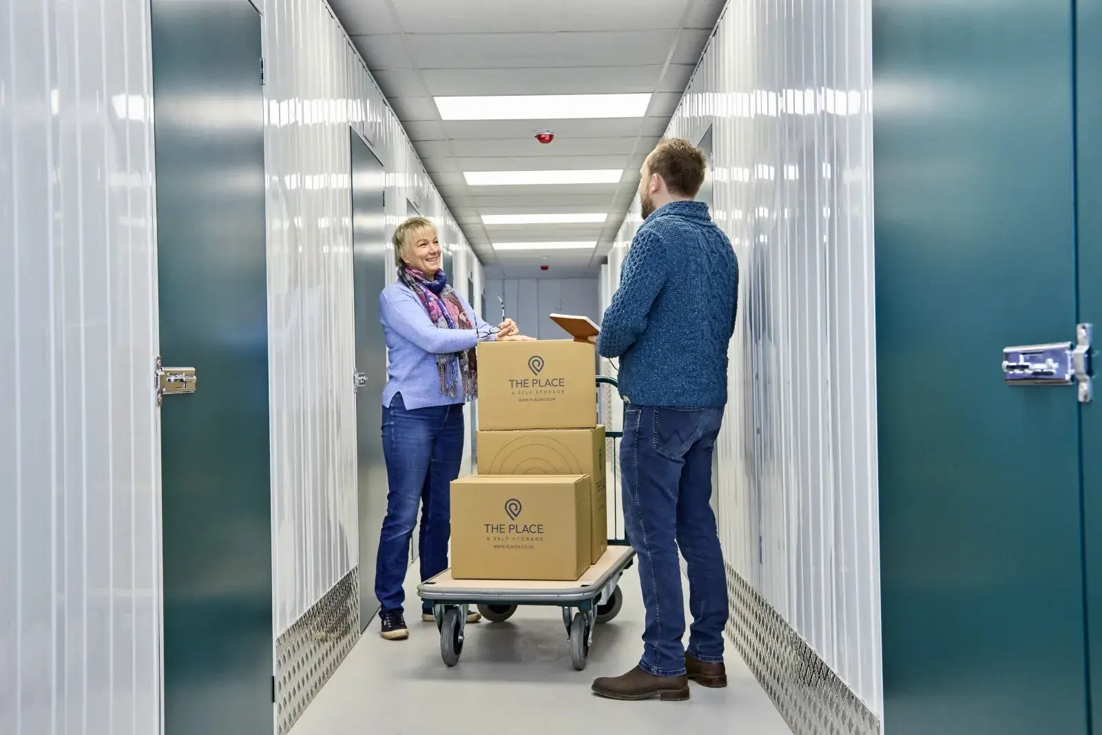 the-place-4-self-storage-customer-and-staff-with-loaded-trolley-1600x1067