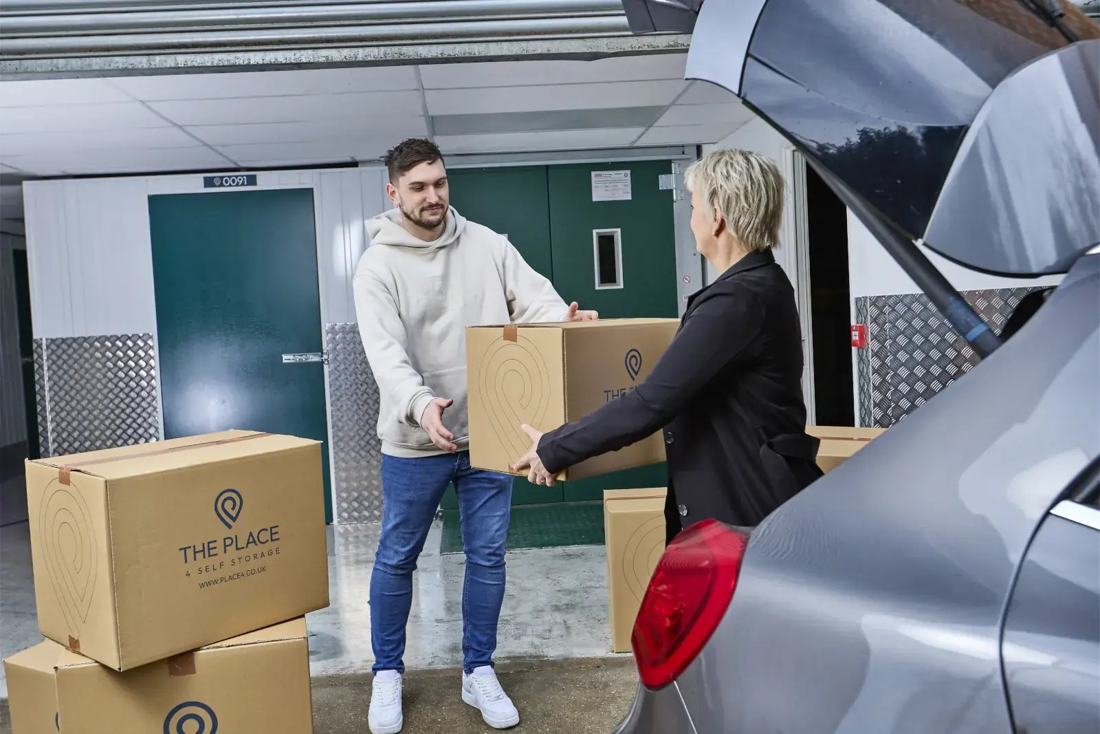 the-place-4-self-storage-unloading-packed-boxes-from-car-for-easy-access-storage-unit-1600x1067