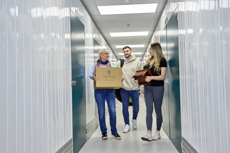 the-place-4-self-storage-family-customers-carry-items-to-secure-storage-unit-800x533