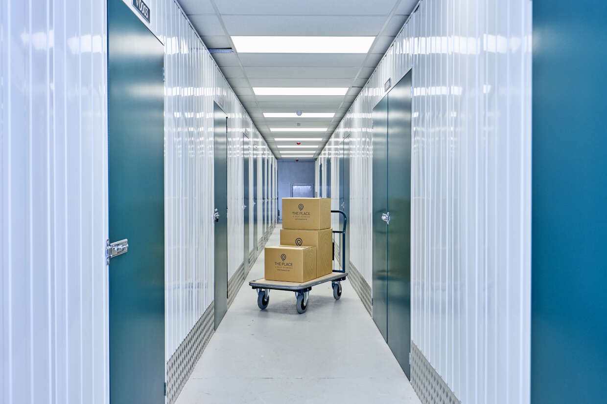the-place-4-self-storage-corridor-with-trolley-and-branded-boxes-1240x827
