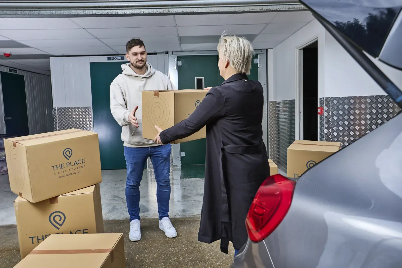 the-place-4-self-storage-customers-unloading-boxes-from-car-to-move-to-easy-access-storage-unit-1600x1067