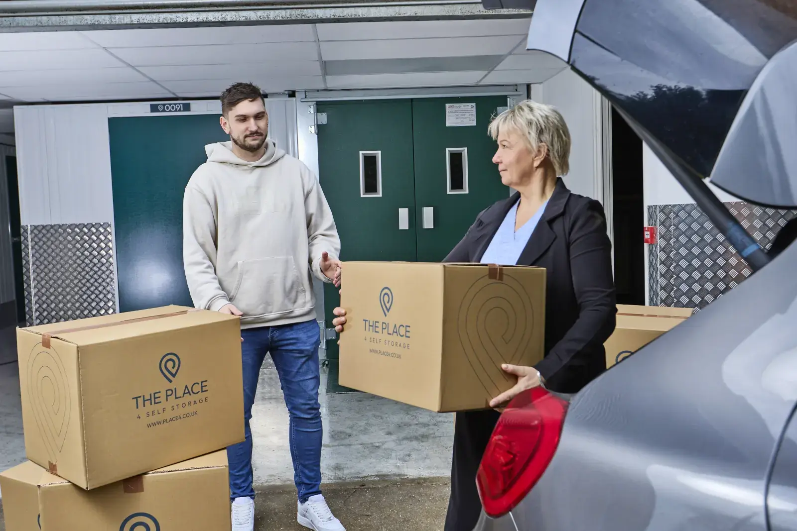 the-place-4-self-storage-customers-unloading-packed-boxes-from-car-easy-storage-unit-access-1600x1067