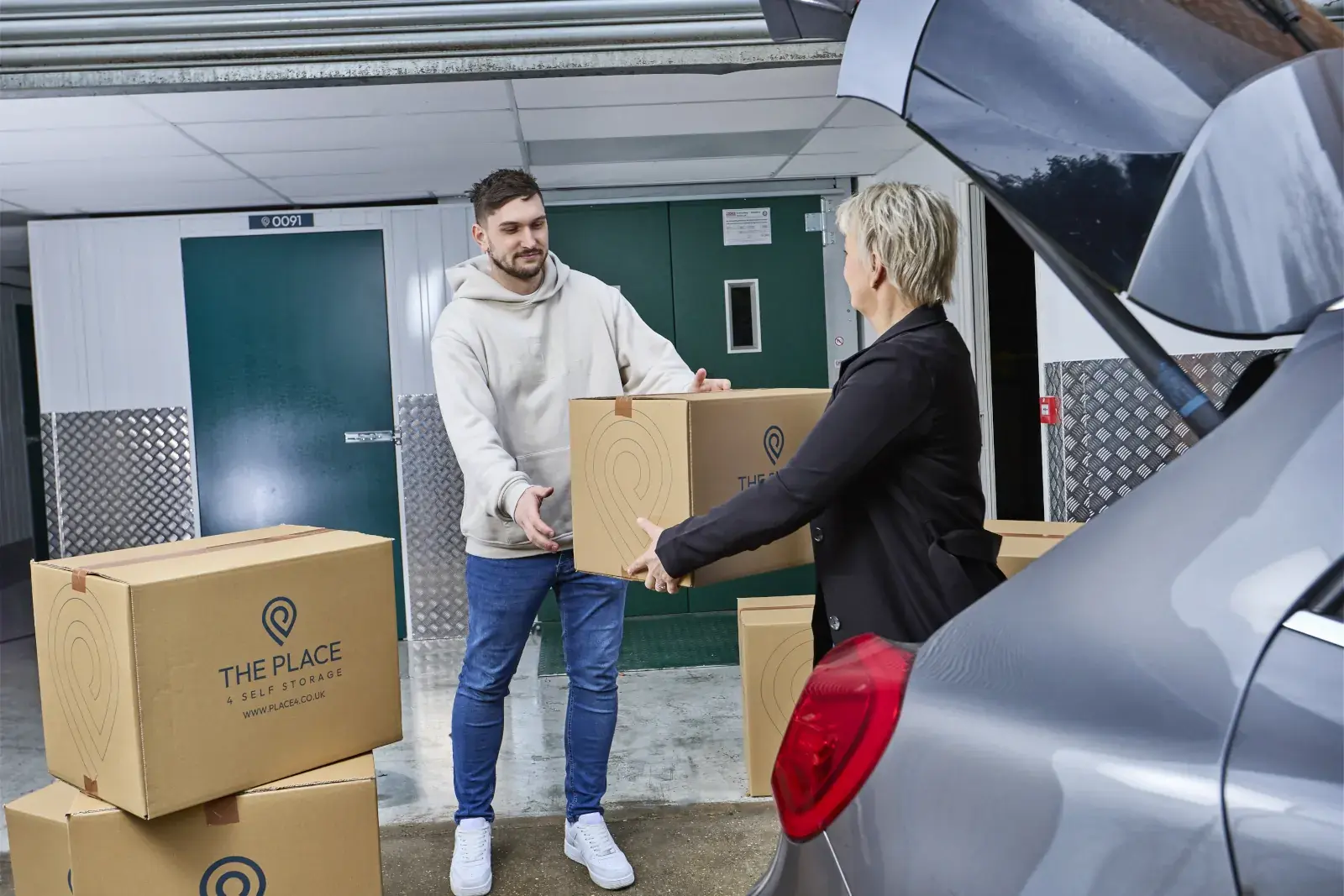 the-place-4-self-storage-unloading-packed-boxes-from-car-for-easy-access-storage-unit-1600x1067